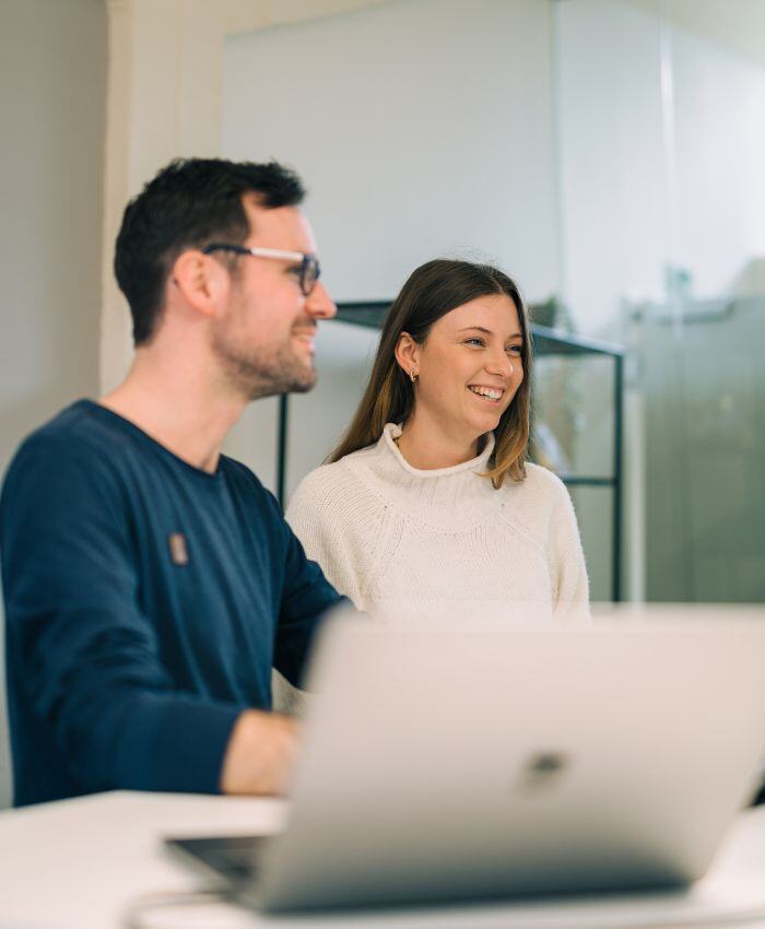 Two colleagues working on computer as symbol for Integration of Vue.js and Salesforce API