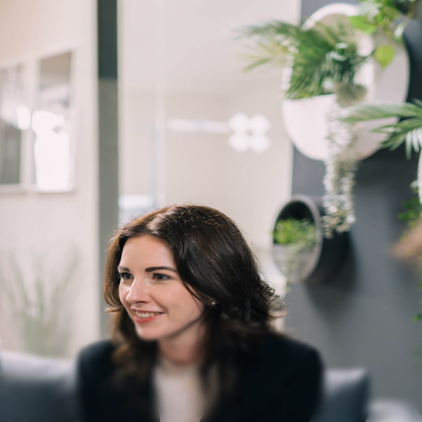 Close-up of the backgound with green plants on the wall. | Full Service B2B E-commerce Agency SUNZINET