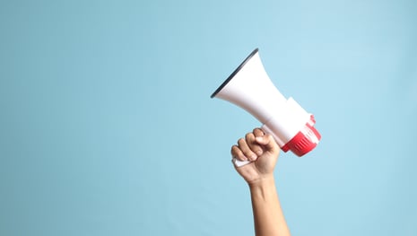Hand with megaphone as a symbolic image for a successful B2B campaign