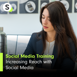 A young woman with long dark hair is sitting at a desk, looking down at a document or digital device in a professional setting. She appears focused on her task. | brand awareness SUNZINET