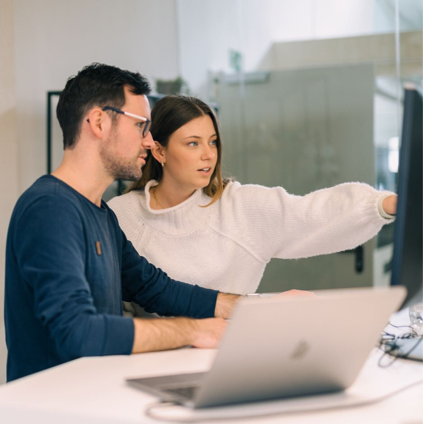 Two people look at results on a screen