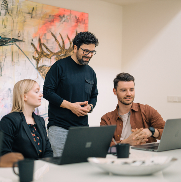 Three people discussing in a meeting